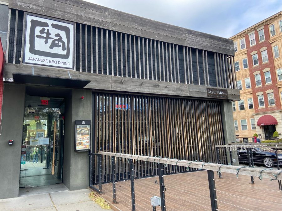 The front of Gyu Kaku displays unique wooden architecture and a connected area for outside dining.