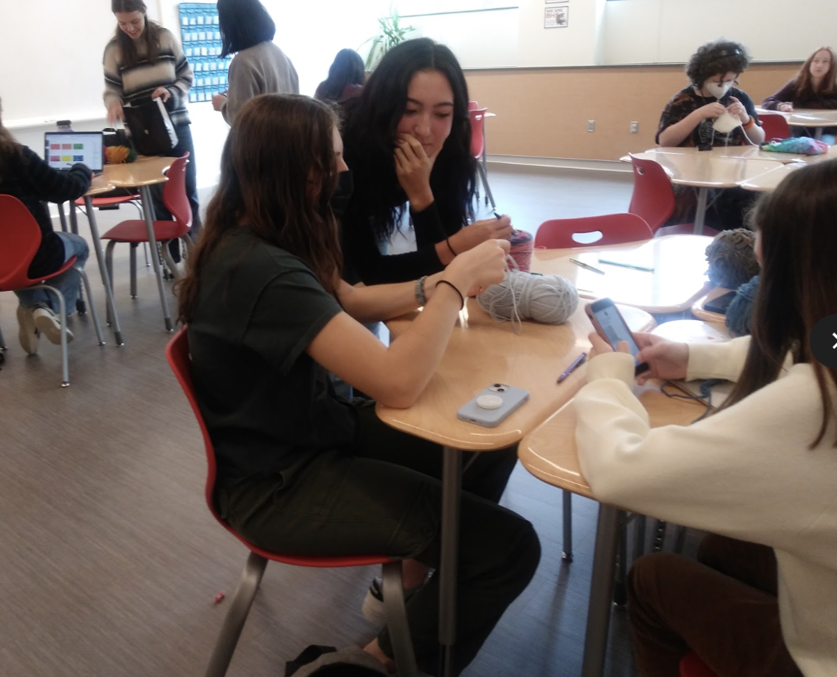 Crochet Club leader Jaime Khynes puts her teaching skills to the test as she helps junior Jasmine Spanjaard crochet a granny square in the second meeting of the Crochet Club this school year. 