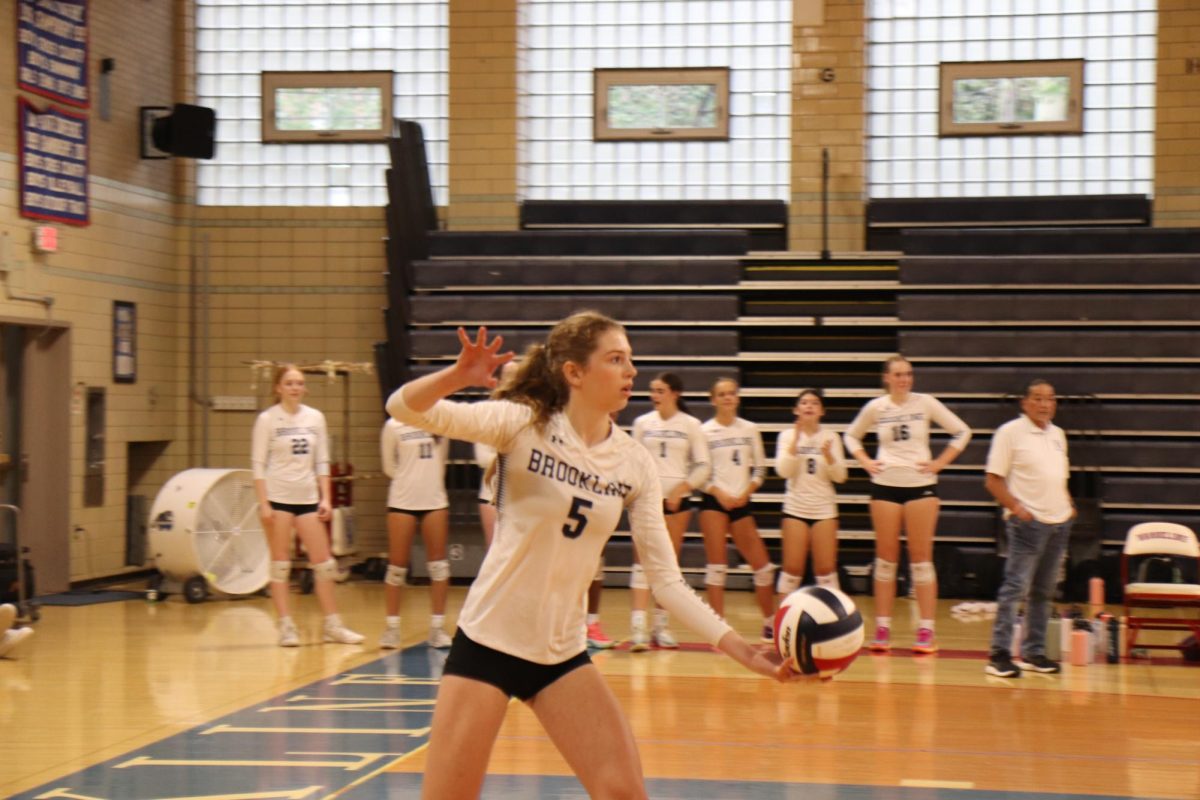 Girls varsity volleyball sophomore Molly Tipton serves in the Warriors game against the Weymouth Wildcats. 