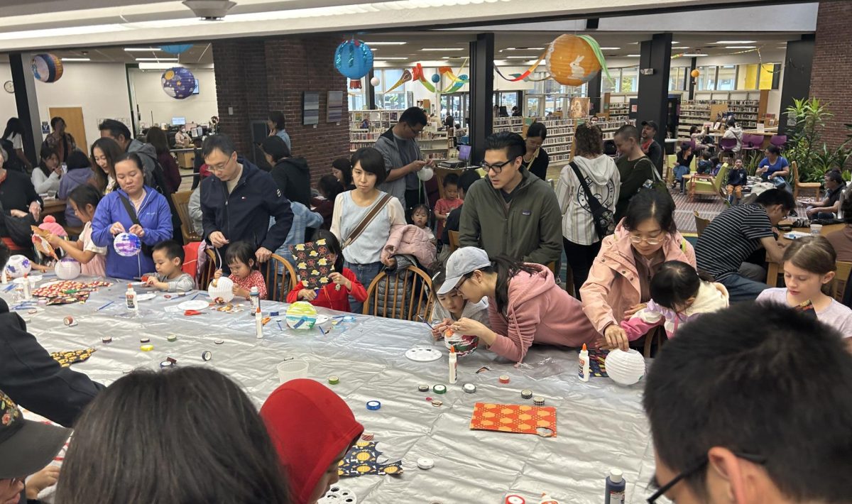 Community members, including many parents and children, decorated lanterns together on Saturday, Sept. 21 at the Coolidge Corner Library's Mid-Autumn Festival.