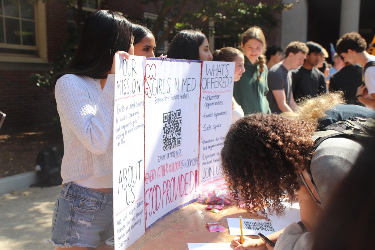 Clubs like the Girls in Med Club, pictured above, brought posters and candy hoping to attract new members at the Club Fair on Wednesday, Sept. 11 in the quad.