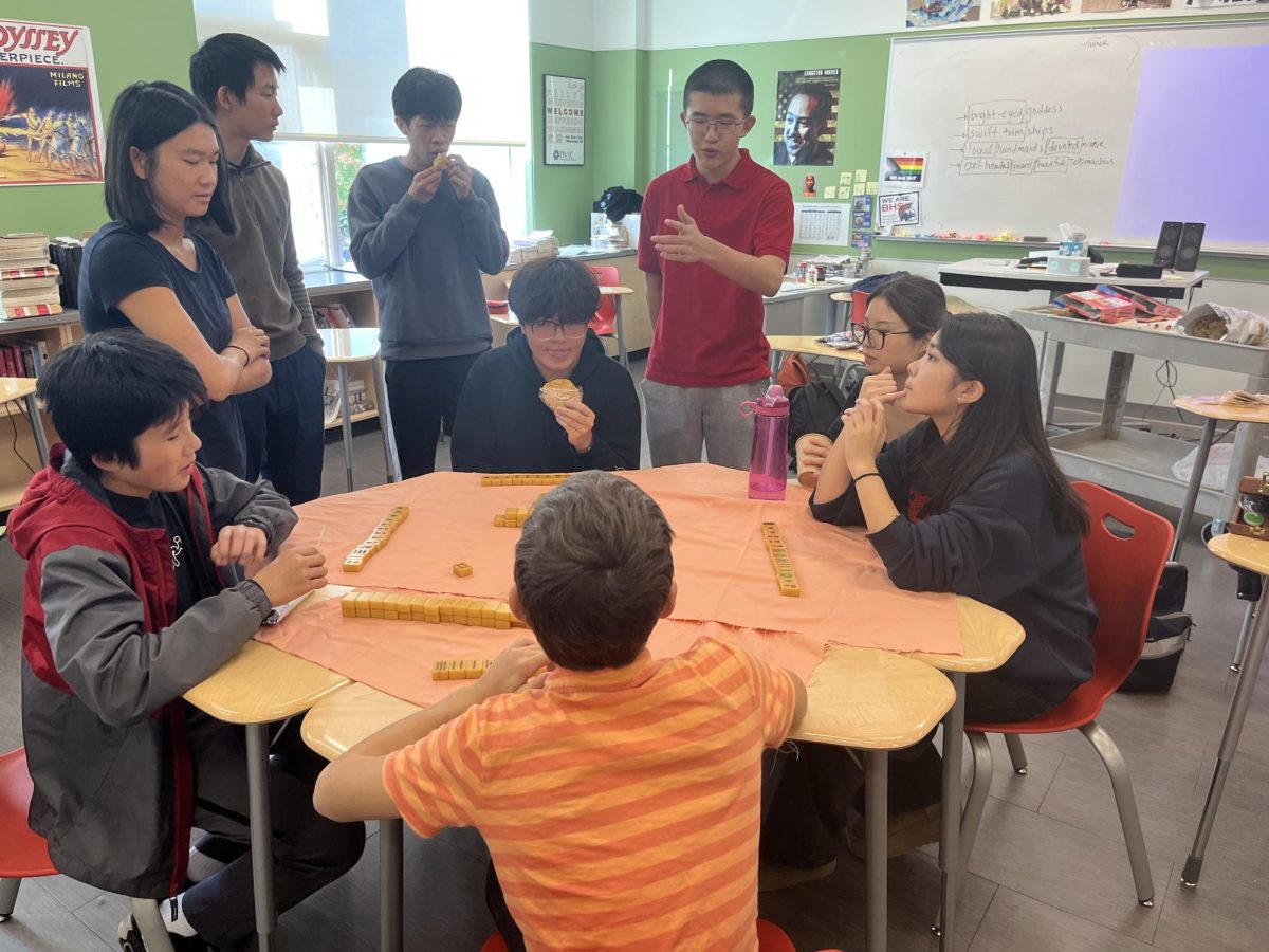 Senior Melanie Ho teaches club members, both new and old, how to play mahjong, a traditional Chinese tile game. 