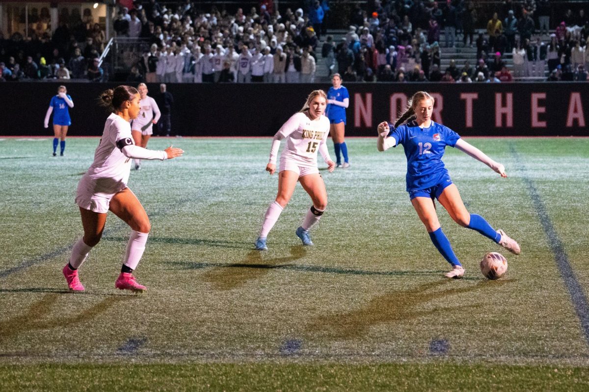 Sophomore and defender Jamie Magee fends off King Philip attackers in the girls soccer state quarter-finals match up. The girls varsity soccer team defeated King Philip Regional High School (King Philip) 2-0 on Thursday, Nov. 14 at Parsons Field, punching their ticket to the final four for the second straight year.