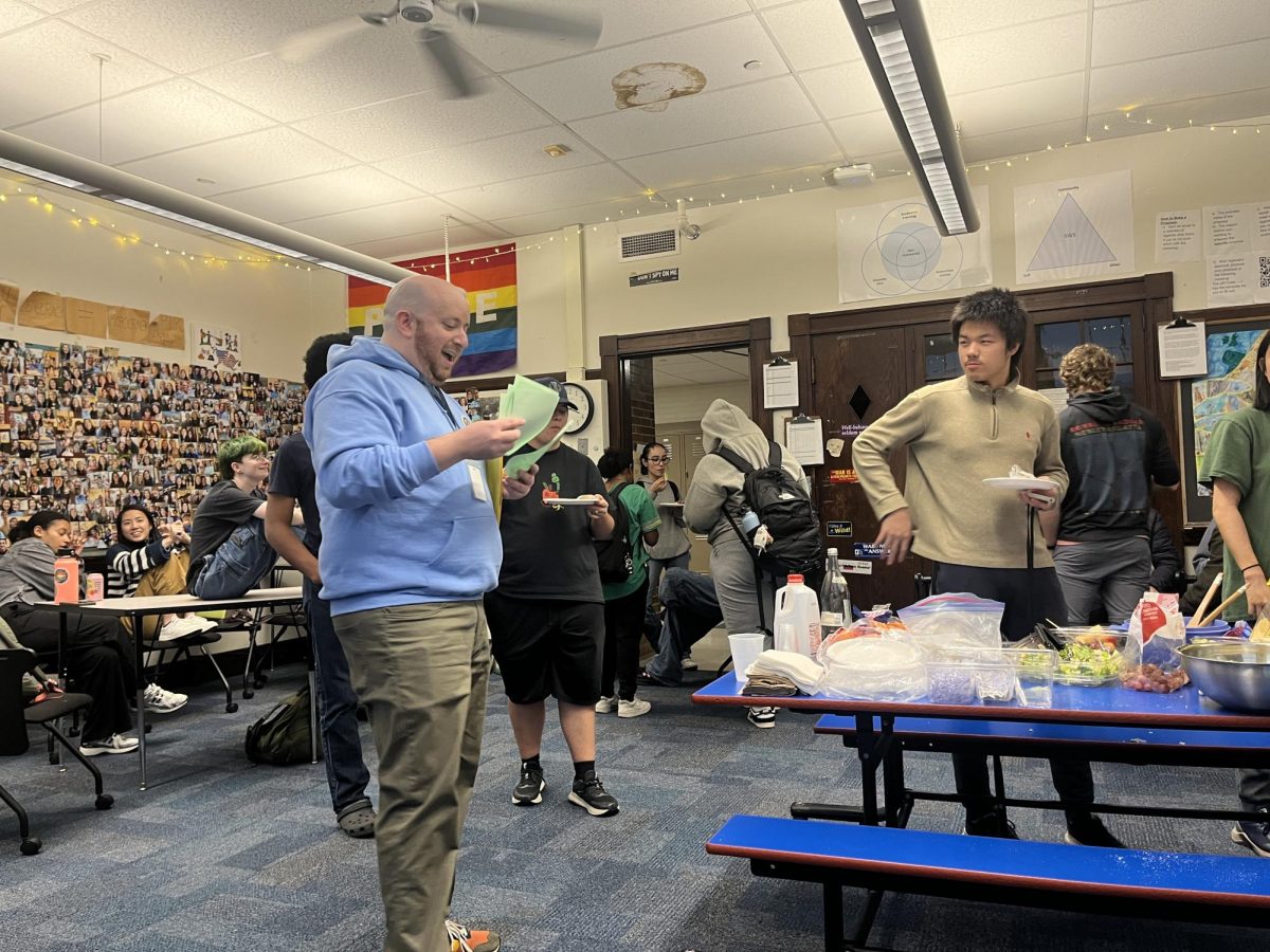 Math teacher Adam Fried facilitated a group trivia game at the Friendsgiving potluck hosted by the QSP, AALSP and LEAP on Thursday Nov. 21.