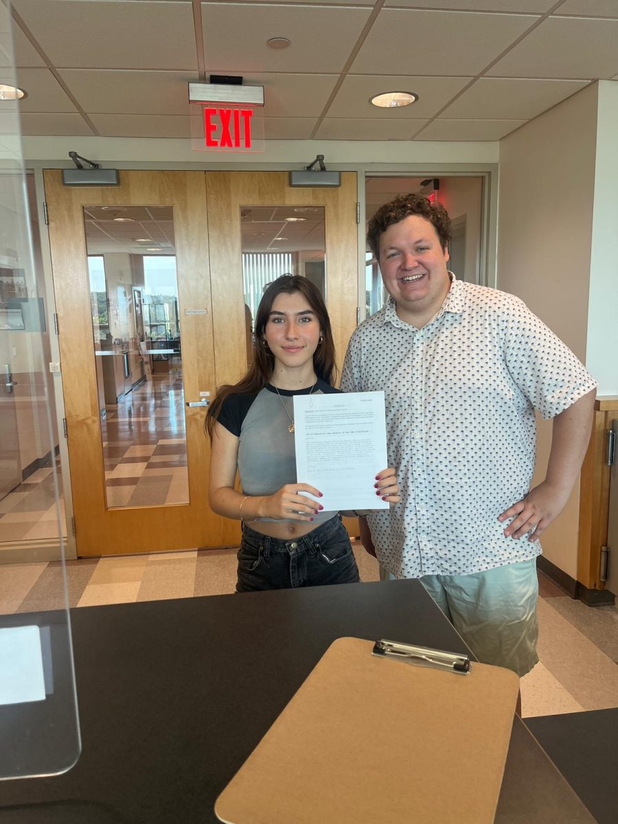 Maria Udalova and Alec Lebovitz, a Town Meeting and Advisory Committee member, hold up their
warrant article at town hall after collecting numerous signatures in favor of nuclear disarmament.