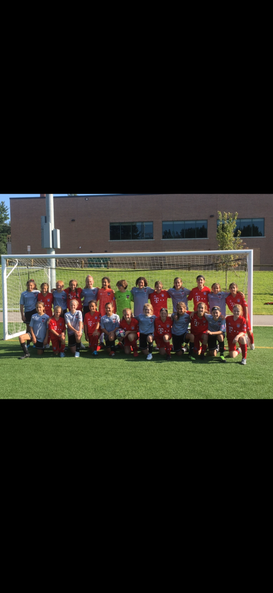 In this photo, players on Eva Berkson’s club team from 2019 gather after a hard fought game. Berkson now plays on girls varsity soccer and plays both with and against some of these girls.