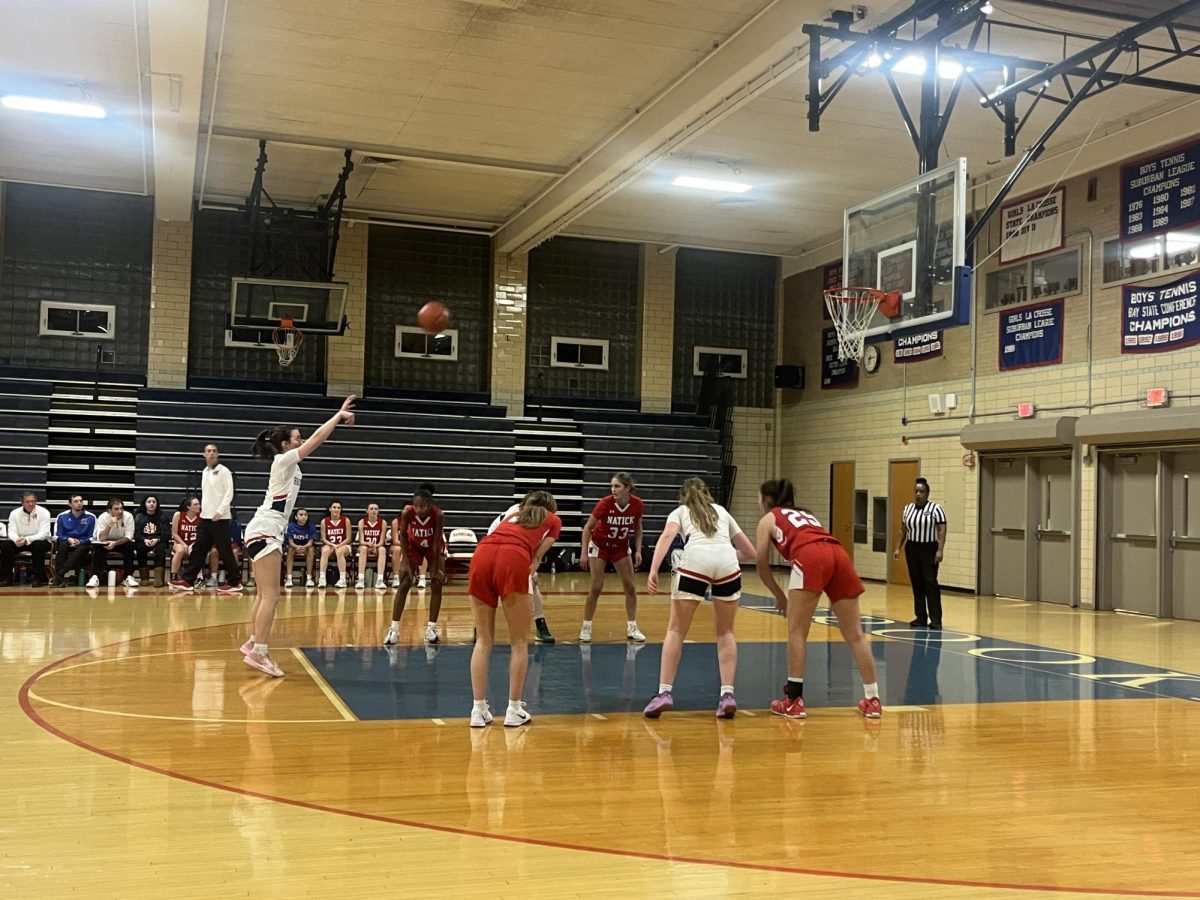 Junior captain Ivy Wheelers sinks her free throw against the Natick Redhawks in the Warriors fire game of the season on Friday, Dec. 13 .