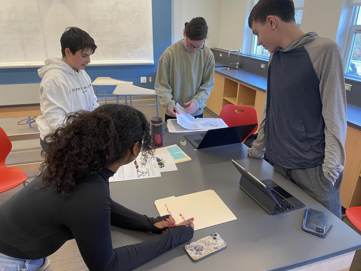 Students in ACE discuss their elemental superheroes, an annual project originally created by ACE science teacher Benjamin Little to spark enthusiasm about chemistry.