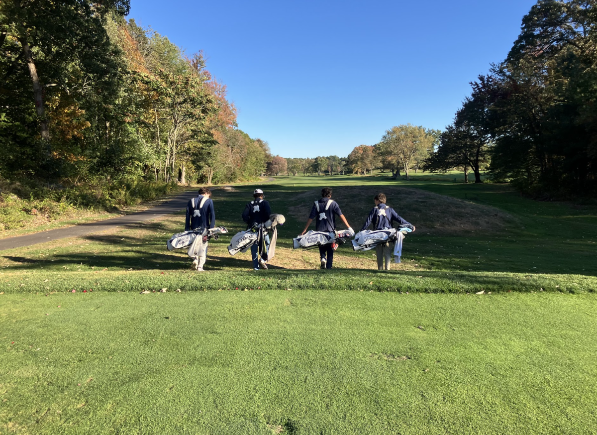 Walking down the Robert T. Lynch Municipal Golf Course with clubs in their bags, the JV boys golf team looks to develop skills and swings in a low stress environment.