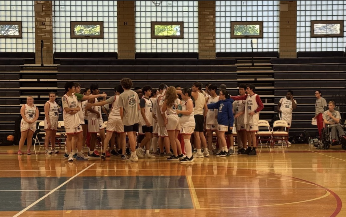 The Unified basketball team huddles before a game. The team’s captains have helped build an environment filled with encouragement.