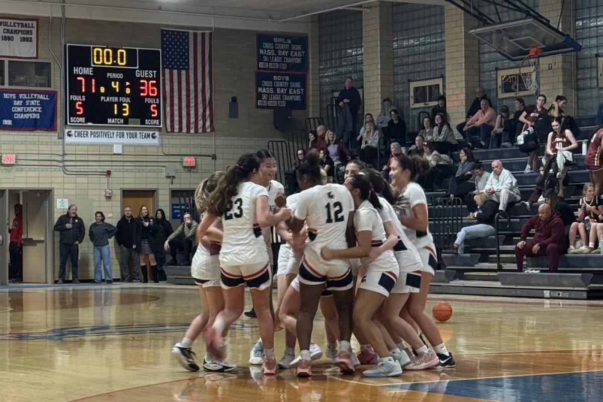 The Warriors celebrate after defeating the Weymouth Wildcats, 71-36 to extend their winning streak to four. The game took place at Schluntz Gymnasium on Monday, Jan. 6.