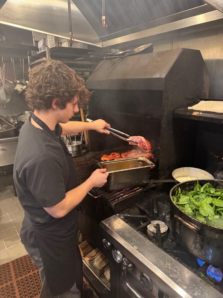 Roland Plante cooks a dish at La Morra, where he is employed as the restaurant's youngest chef. After taking Culinary Exploratory as a freshman, his passion quickly grew into more than just a hobby.