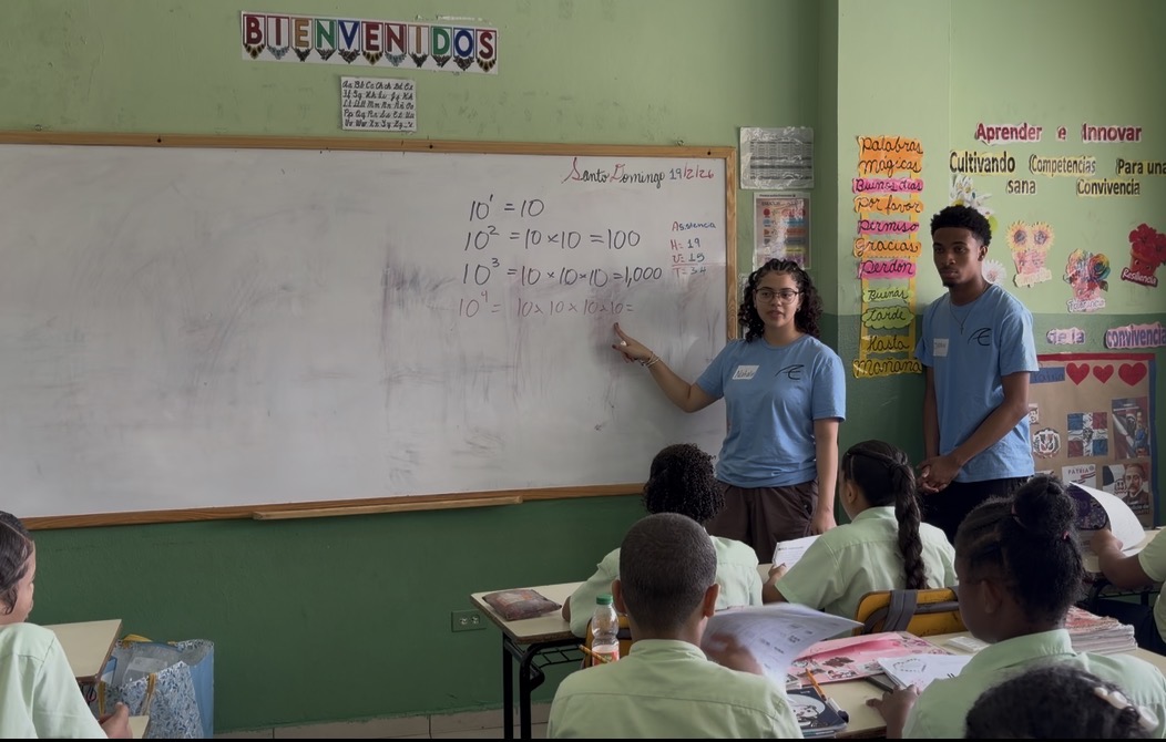 Two ACE students teach exponents to a math class at La Escuela Café con Leche. ACE students traveled to the Dominican Republic over February vacation to help the school and build community, mainly organized by math teacher Julie James.