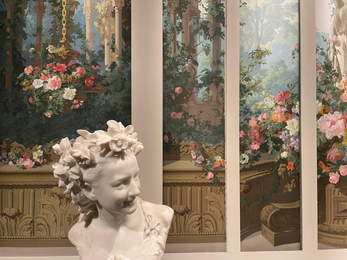 Jean Baptiste Carpeaux’s “Bust of Flore” sits in front of Edouard Muller’s “Jardin d’Armide” wallpaper. The “Framing Nature” exhibit features many mediums.