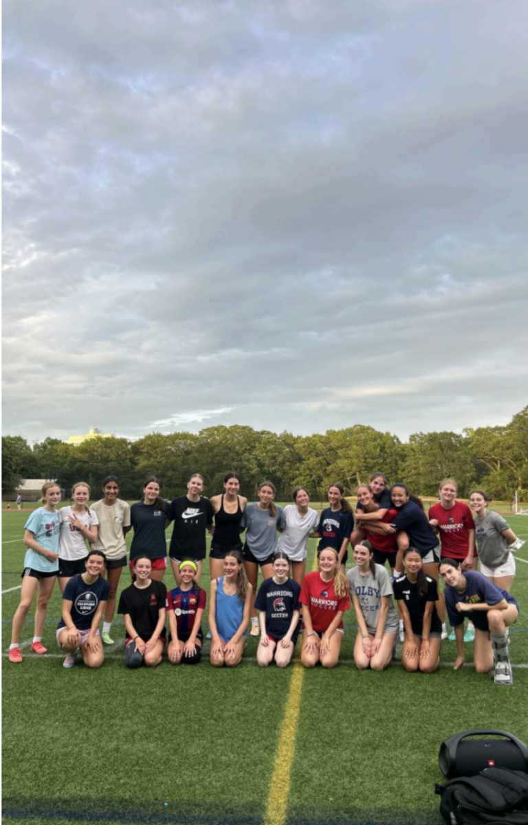 Athletes that range from freshmen to seniors pose for a picture at
Downes Field after a girls soccer summer captains practice.